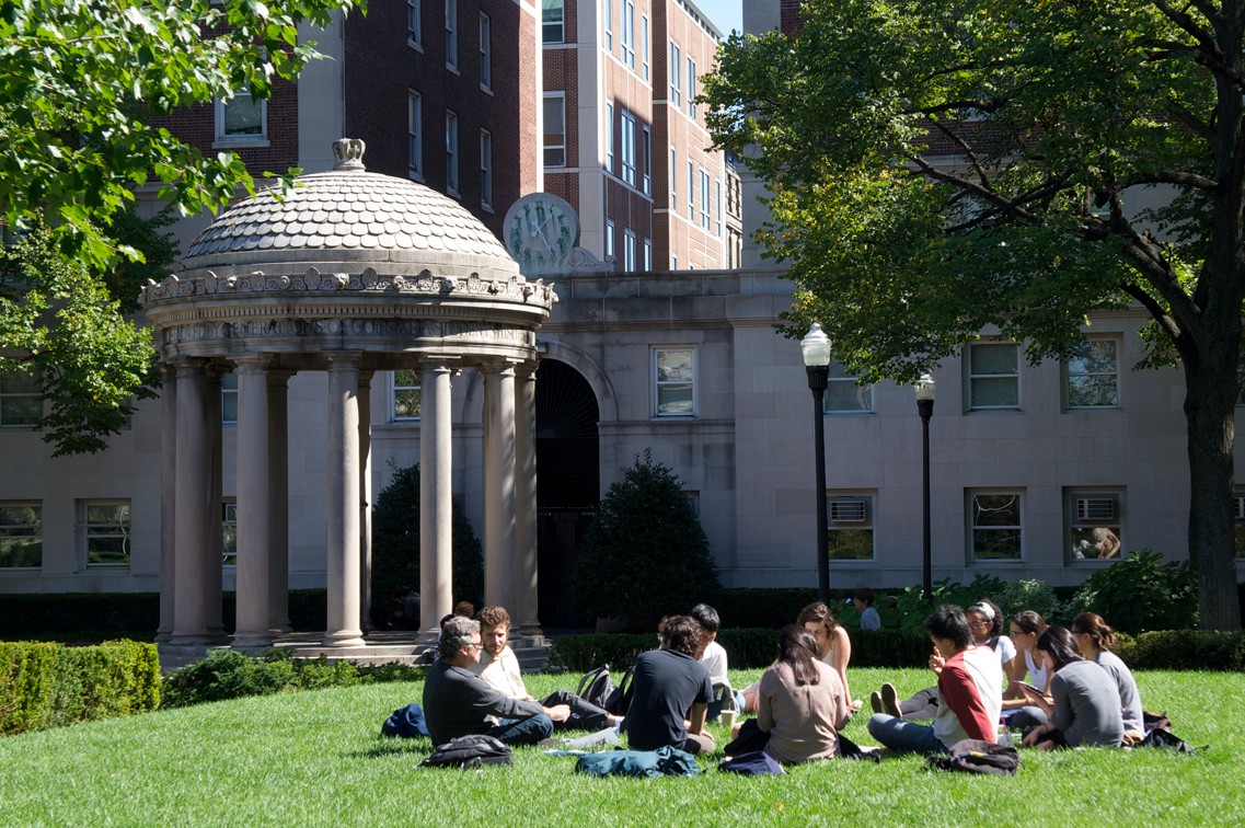 Students sitting outside on campus