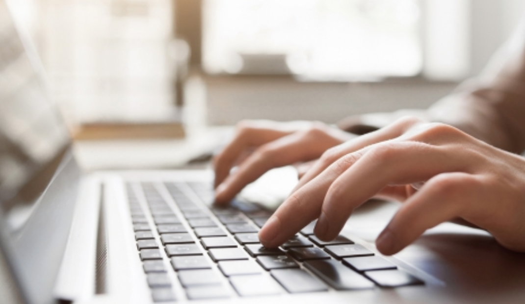 Hands typing on a keyboard